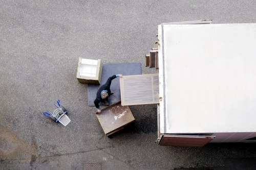 Local piano moving team navigating a narrow staircase in a Holland Park property