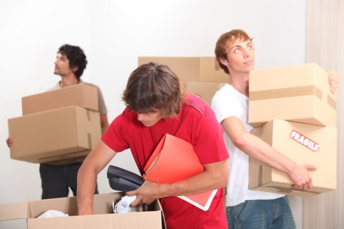 Packed moving boxes and furniture prepared for transport in Holland Park