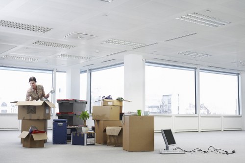Professional movers handling office furniture and equipment