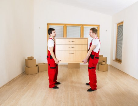 Trained removals staff handling furniture with care in Holland Park